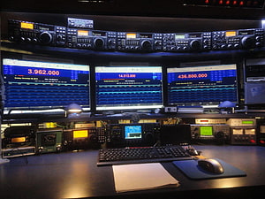 Professional Ham Radio Station Setup with Multiple Transceivers and Digital Frequency Monitors HD wallpaper