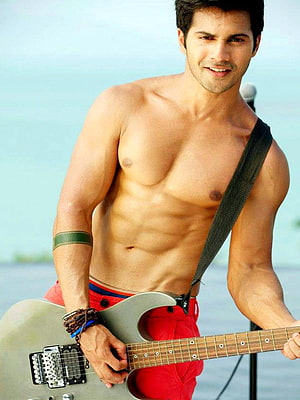 Varun Dhawan shirtless with electric guitar on a beach HD phone wallpaper