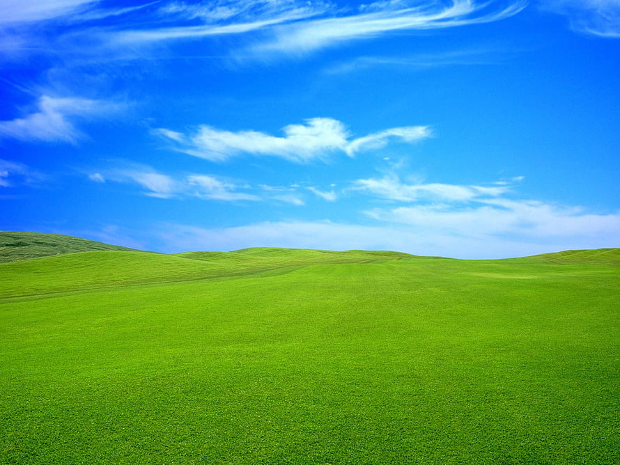 Vast Green Rolling Hills Under a Bright Blue Sky with Wispy Clouds HD wallpaper
