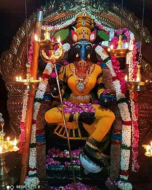 Ornate Ganesha Murti Adorned With Flower Garlands And Oil Lamps In Temple Setting HD phone wallpaper