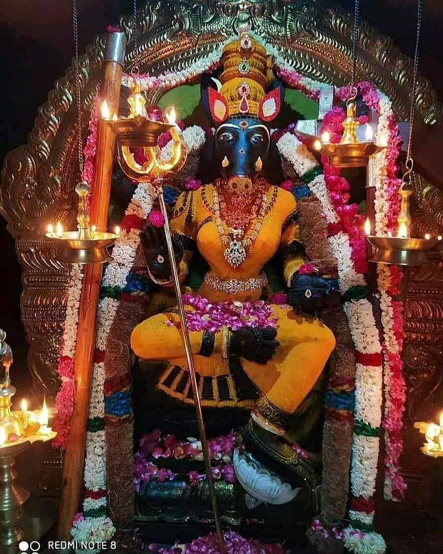 Ornate Ganesha Murti Adorned With Flower Garlands And Oil Lamps In Temple Setting HD phone wallpaper