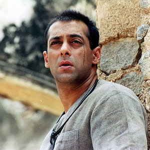 Salman Khan in Tere Naam, emotional close-up against a rustic stone wall HD phone wallpaper