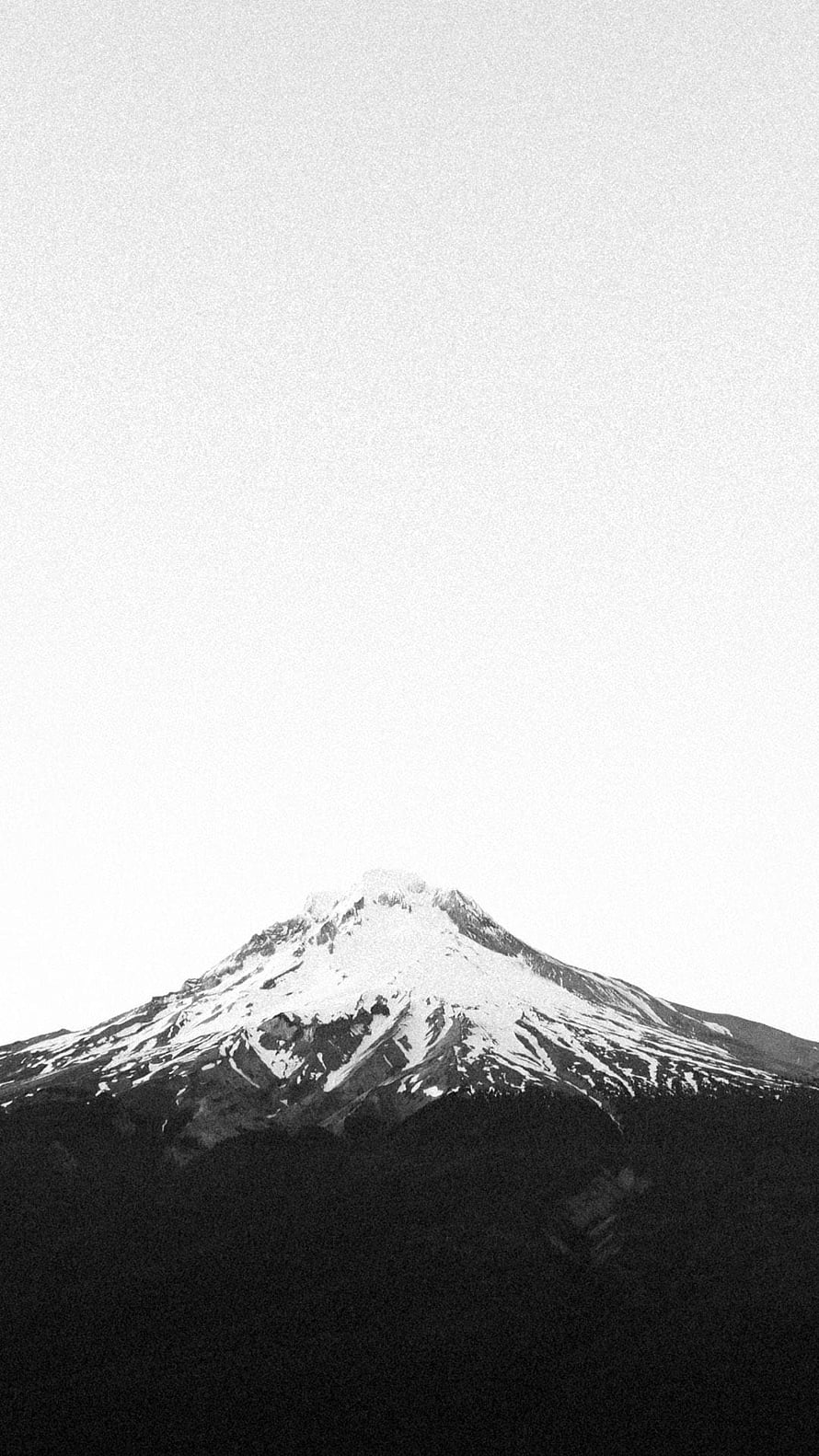Monochrome Minimalist Snow-Capped Mountain Peak Against a Pale Sky HD phone wallpaper