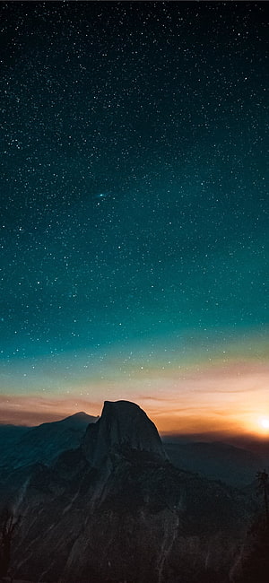 Starry Night Sky Over Mountain Peak at Twilight with Aurora Glow HD phone wallpaper