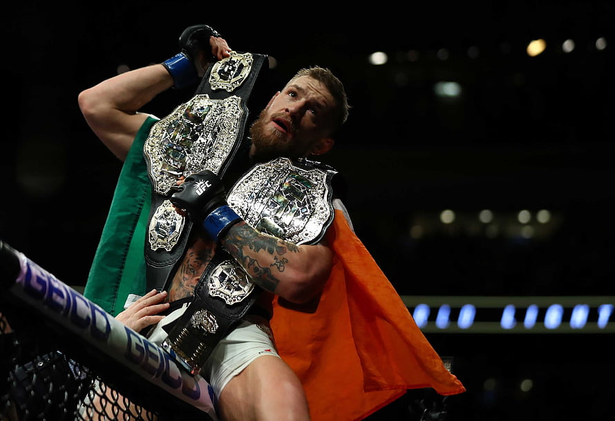 Conor McGregor Celebrates UFC Championship Victory with Irish Flag in Octagon HD wallpaper