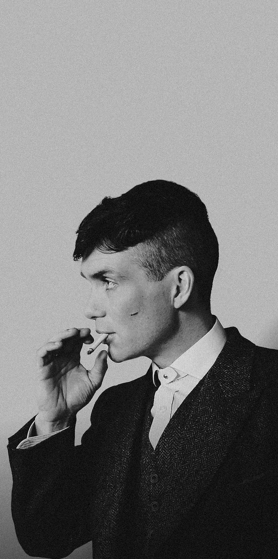 Thomas Shelby in a Three-Piece Suit Smoking a Cigarette in Black and White HD phone wallpaper