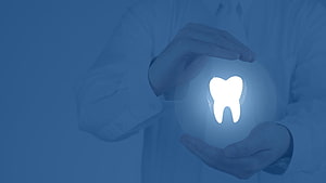 Dentist Holding Glowing Tooth Icon in Blue Medical Concept HD wallpaper