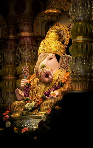 Dagdusheth Ganpati Murti Adorned in Gold and Marigold Garlands in Temple Setting HD phone wallpaper