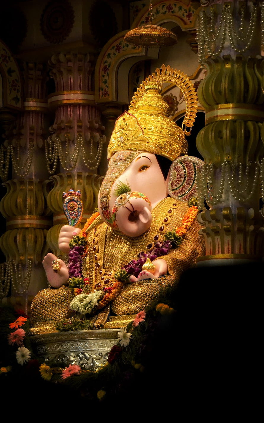 Dagdusheth Ganpati Murti Adorned in Gold and Marigold Garlands in Temple Setting HD phone wallpaper