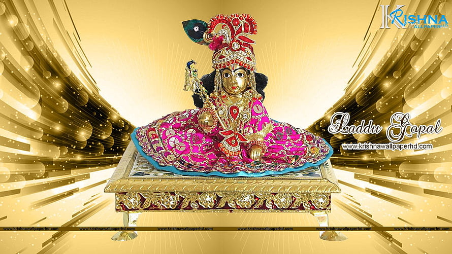 Laddu Gopal Krishna Idol in Ornate Pink Attire on Golden Pedestal with Radiant Background HD wallpaper