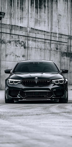 Black BMW M5 F10 Front View Against Concrete Wall HD phone wallpaper