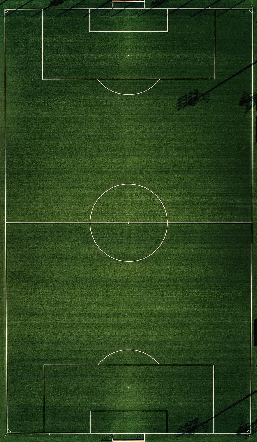 Aerial View of an Empty Soccer Pitch with White Field Markings on Green Grass HD phone wallpaper
