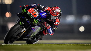 Fabio Quartararo on Yamaha YZR-M1 during a high-speed corner at night HD wallpaper