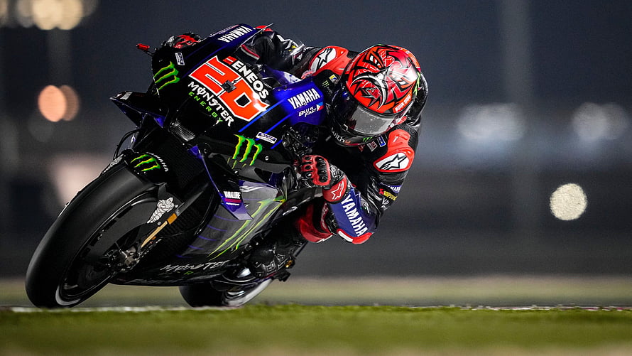 Fabio Quartararo on Yamaha YZR-M1 during a high-speed corner at night HD wallpaper