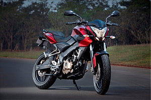 Red Bajaj Pulsar 200 NS Street Motorcycle Parked on Asphalt Road HD wallpaper