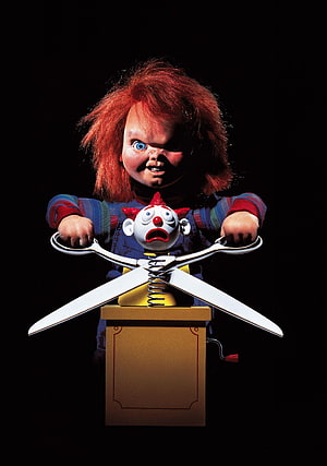 Chucky the Killer Doll Operating a Jack-in-the-Box Scissor Mechanism on a Black Background HD phone wallpaper