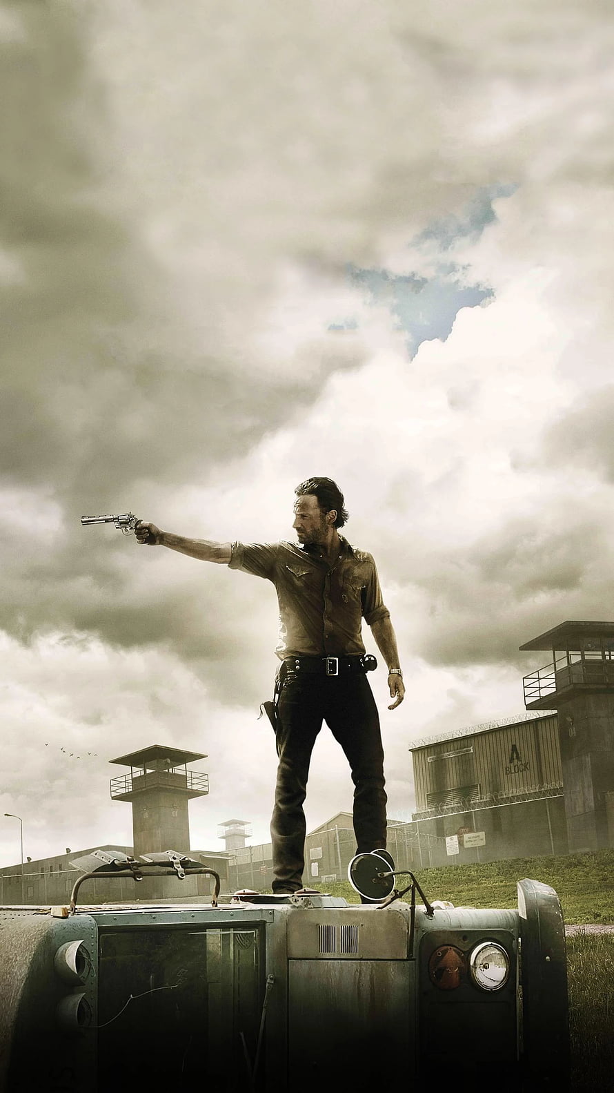 Rick Grimes Aiming Revolver on Vehicle Roof in The Walking Dead Prison Scene HD phone wallpaper