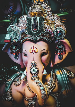 Ornate Ganesha Murti with Intricate Jewelry and Elaborate Crown HD phone wallpaper