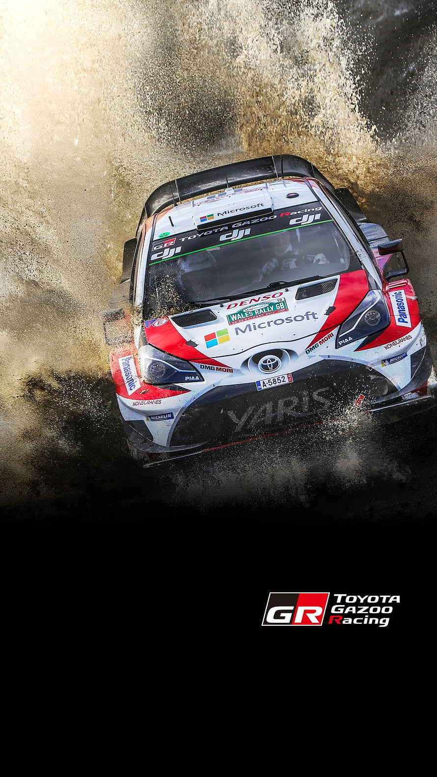 Toyota GR Yaris Rally1 kicking up mud during a high-speed WRC stage HD phone wallpaper