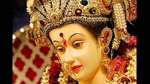 Maa Ambe Divine Idol With Ornate Crown And Floral Garland HD wallpaper