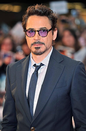 Robert Downey Jr in a dark suit and tortoiseshell sunglasses at a red carpet event HD phone wallpaper