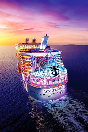 Wonder of the Seas cruise ship sailing at sunset with vibrant neon lights and ocean wake HD phone wallpaper