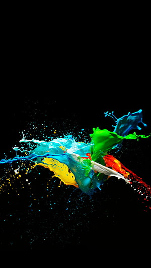 Vibrant multicolored paint splash frozen in motion against a deep black background HD phone wallpaper