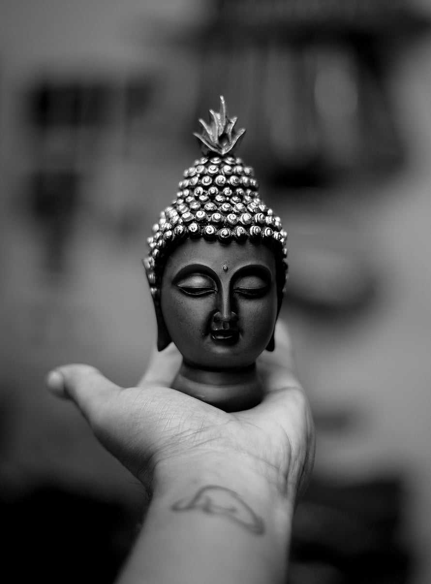 Black and White Buddha Head Sculpture Resting in an Open Palm HD phone wallpaper
