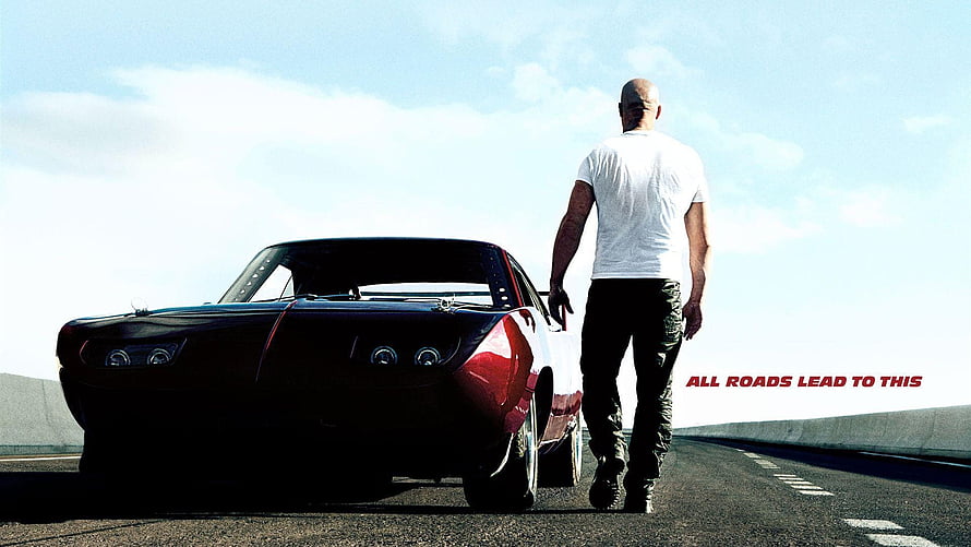 Fast and Furious 7 promotional still featuring a man walking beside a classic muscle car on an open highway HD wallpaper