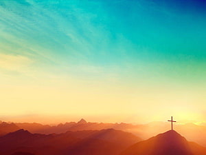 Serene Mountain Sunrise With Cross Silhouette Against Vibrant Gradient Sky HD wallpaper