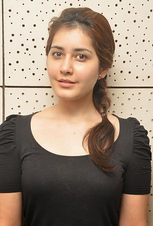 Rashi Khanna Portrait in Black Top with Braided Hair Against Perforated Wall HD phone wallpaper