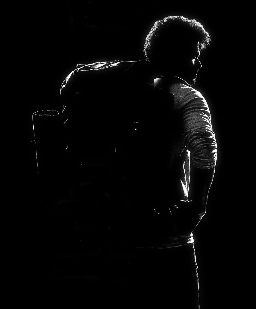 Vijay Varisu First Look Poster Silhouette with Backpack in Dramatic Black and White Lighting HD phone wallpaper