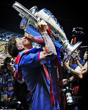 Lionel Messi Kissing The Champions League Trophy During A Victory Celebration HD phone wallpaper