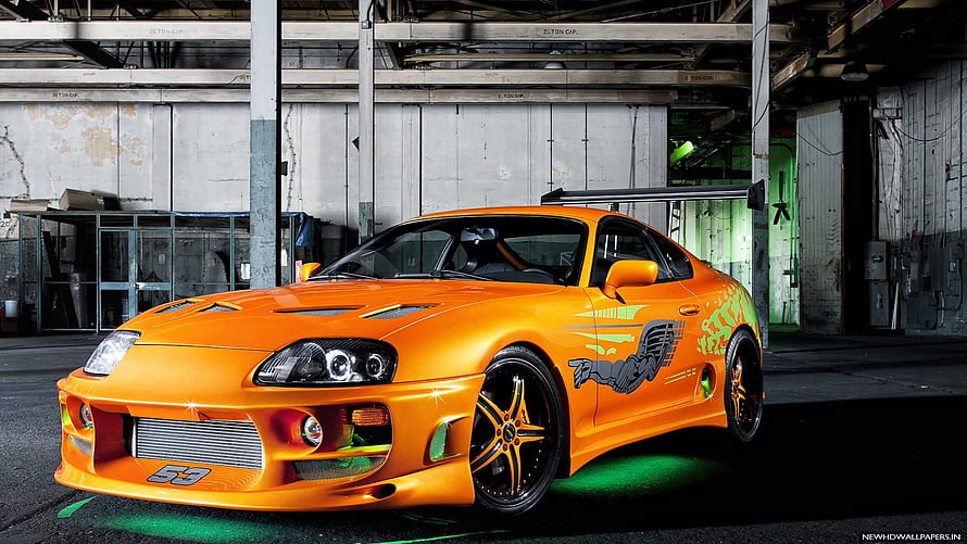 Orange Toyota Supra MK4 with Custom Graphics in Industrial Garage HD wallpaper