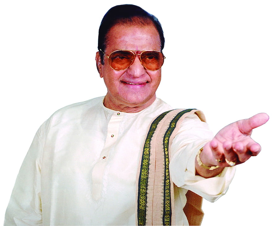 NTR in a cream kurta with green-bordered stole, wearing aviator sunglasses and pointing forward HD wallpaper