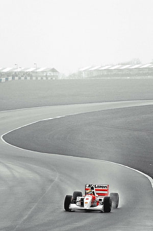 Ayrton Senna McLaren F1 Car Cornering on a Misty Race Track HD phone wallpaper
