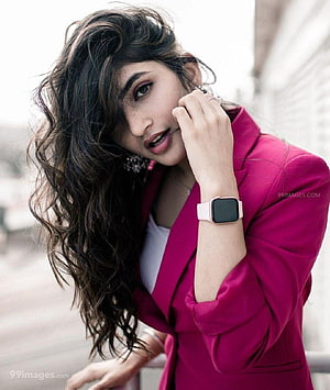 Sree Leela in a vibrant magenta blazer with a smartwatch and long wavy hair HD phone wallpaper