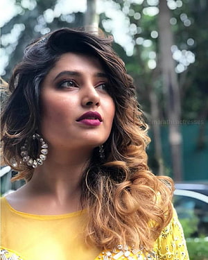 Prajakta Mali in a yellow embroidered outfit with wavy hair and statement earrings HD phone wallpaper