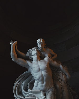Dramatic Greek Marble Sculpture of a Fallen Warrior and Female Figure in a Dark Rotunda HD phone wallpaper