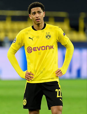 Jude Bellingham in Borussia Dortmund Yellow Home Kit Standing on the Pitch HD phone wallpaper