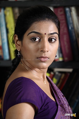 Padmapriya Portrait in Purple Saree with Bookshelf Background HD phone wallpaper