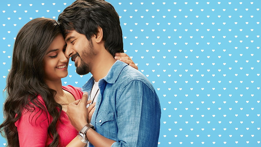 Sivakarthikeyan and Keerthi Suresh in a romantic embrace against a blue heart-patterned background HD wallpaper