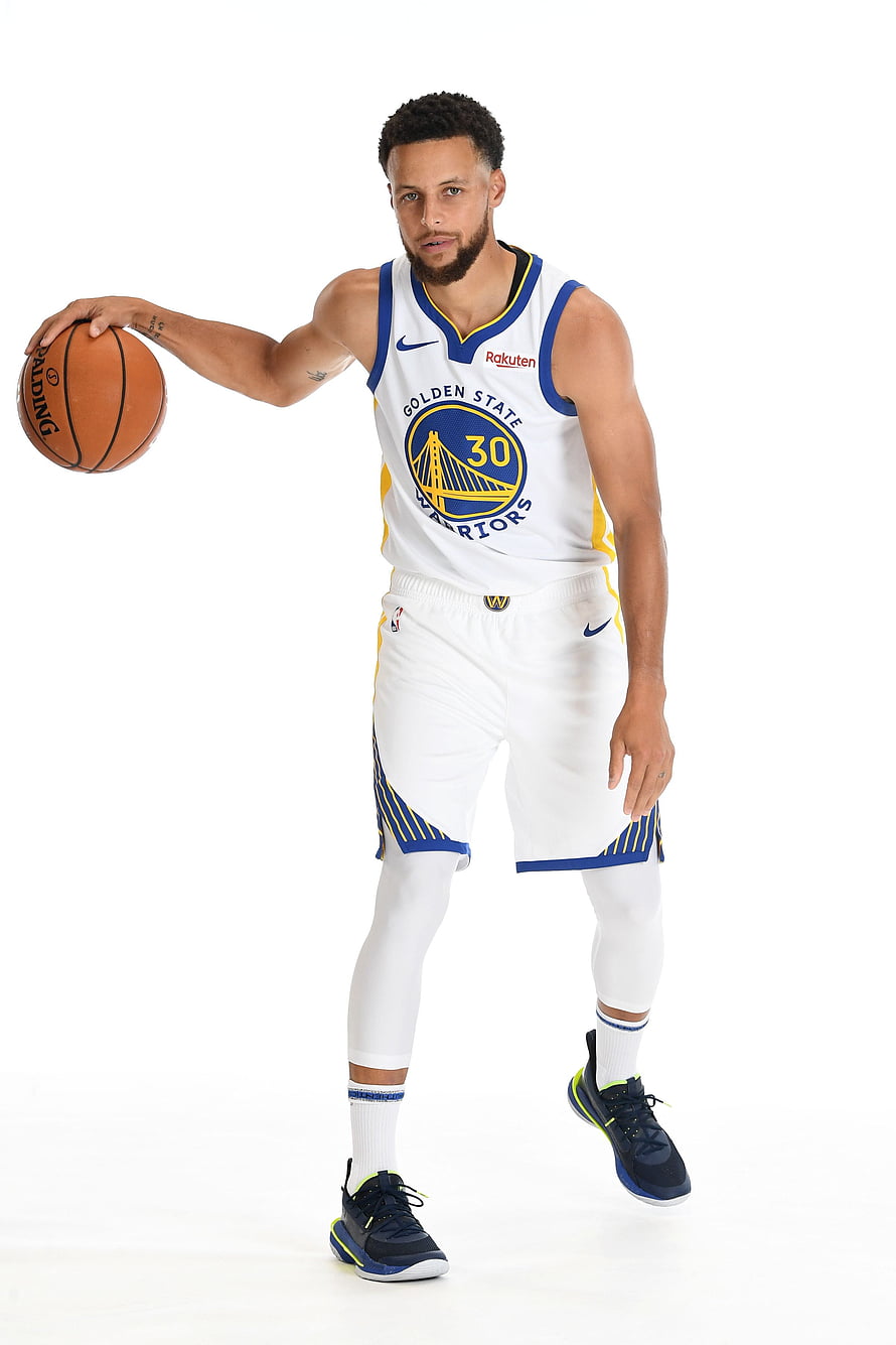 Stephen Curry in Golden State Warriors white home jersey holding a basketball HD phone wallpaper