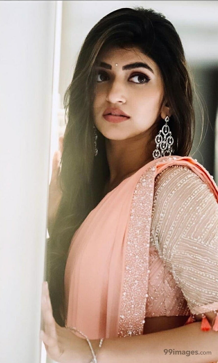 Sree Leela in a peach embroidered saree with long dark hair and ornate jhumka earrings HD phone wallpaper