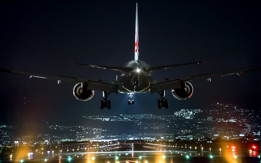 Commercial Jetliner Approaching Runway at Night Over Illuminated City HD wallpaper