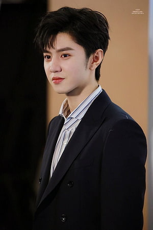 Chen Zhe Yuan in a dark double-breasted suit with a striped shirt, captured in a close-up portrait HD phone wallpaper