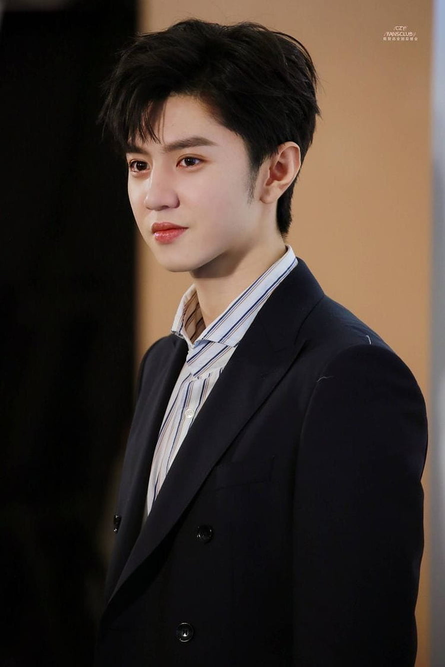 Chen Zhe Yuan in a dark double-breasted suit with a striped shirt, captured in a close-up portrait HD phone wallpaper