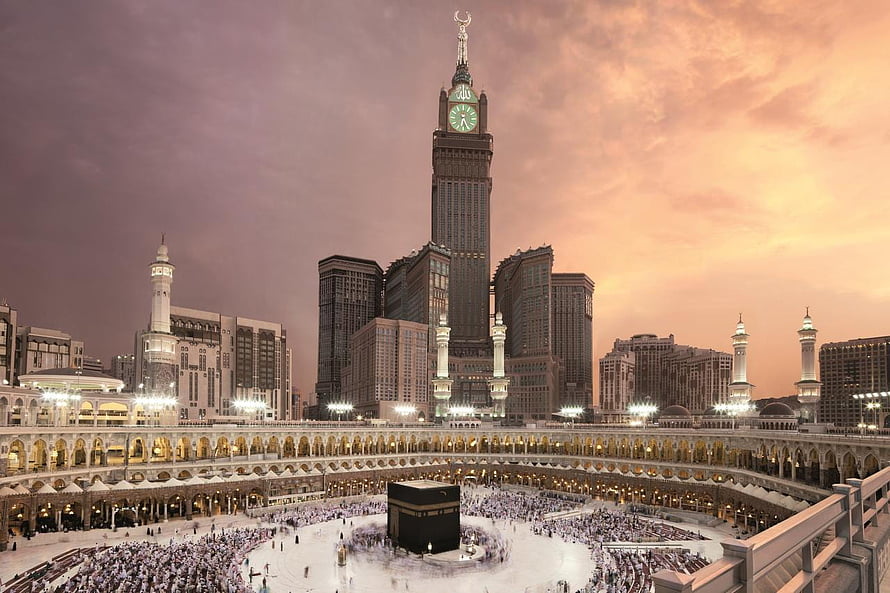 Makkah Clock Royal Tower overlooking the Grand Mosque and Kaaba at sunset HD wallpaper