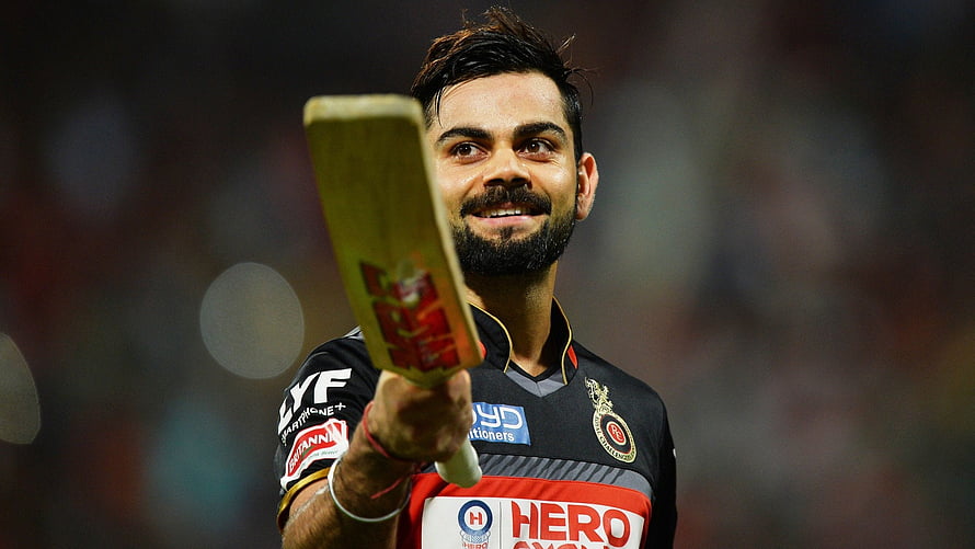 Virat Kohli Raising Cricket Bat in Royal Challengers Bengaluru Jersey HD wallpaper