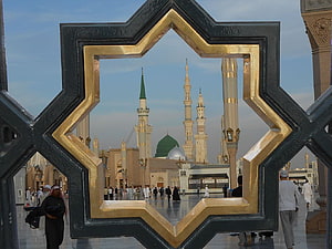 Rasul Allah Mosque in Medina framed by a golden star-shaped window HD wallpaper